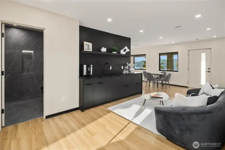 Versatile living – A spacious rec room with sleek built-ins and a modern kitchenette.