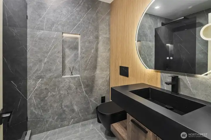 Striking design – Custom ¾ bath with bold stonework and modern finishes.