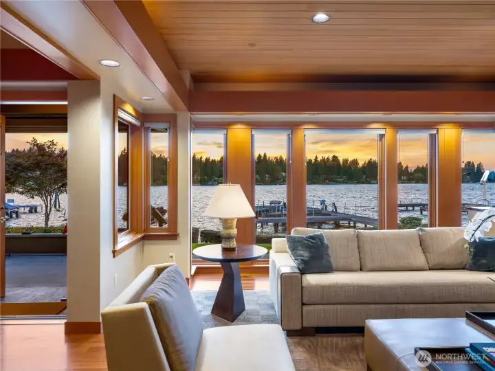 Expansive windows bring the outdoors in, making the living room an inviting space for gatherings with friends or quiet evenings