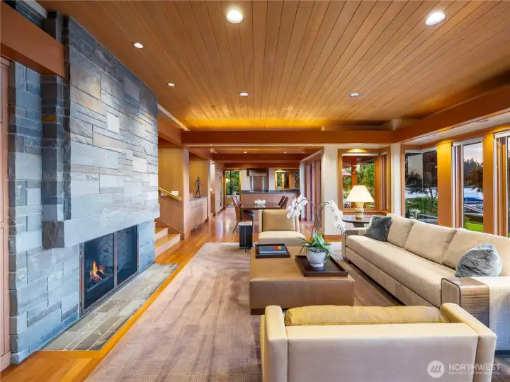 Beautiful open space living room is anchored by Pennsylvania blue stone fireplace facade which wraps around to the foyer