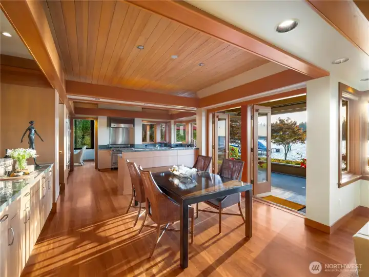 Dining room with french doors that open to the terrace that extends the breadth of the house  Extensive use of tongue and groove paneled hemlock