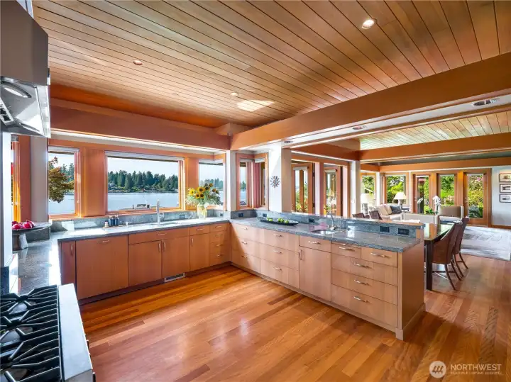 Thoughtful design shines in the kitchen's extensive cabinetry and generous storage. Pantry in utility room to the right with generous storage