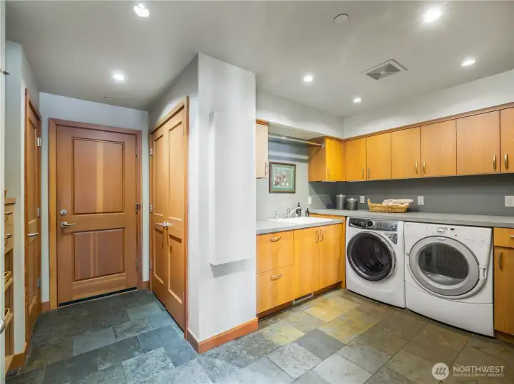 A generously sized laundry room with abundant storage combines function and ease. This serves as additional pantry space.
