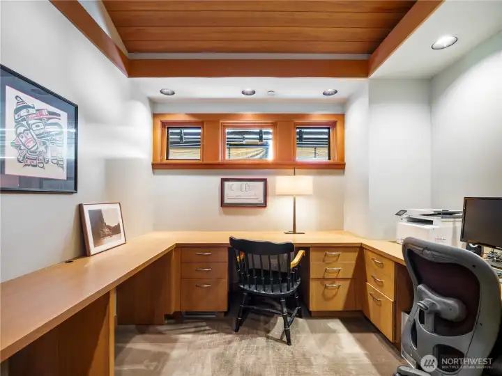 A well-appointed office with custom buil-in desks and storage creates a functional and stylish workspace