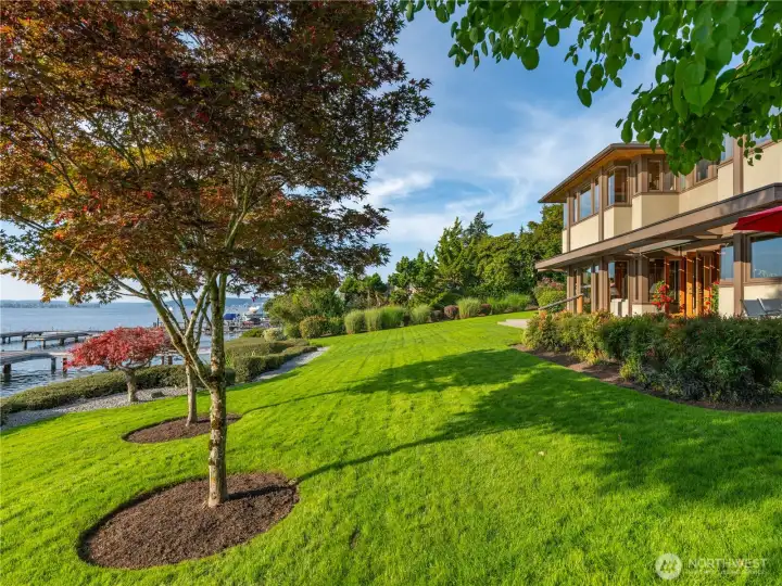 Expansive yard with mature landscaping irrigated from the lake.