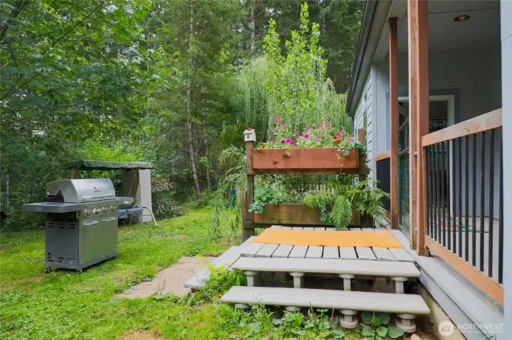 Back covered deck and fenced in back yard.