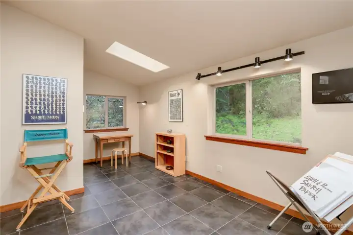 Staged as a studio, this functional guest space can be utilized as a guest room or art studio.