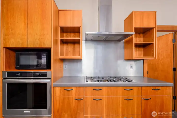 A naturalistic preference to open and floating shelves with build in oven and propane stove top.