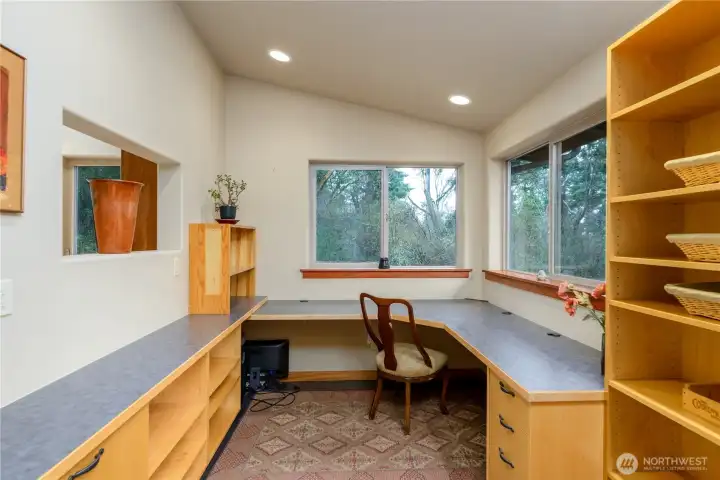 Custom wraparound workspace and built-in shelving create a beautifully integrated area for productivity, study, or reflection.