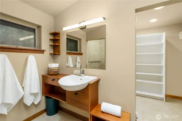 This view highlights the executive bathroom vanity, where soft lighting and refined finishes create a serene space for daily rituals, blending function with a spa-inspired sense of comfort.