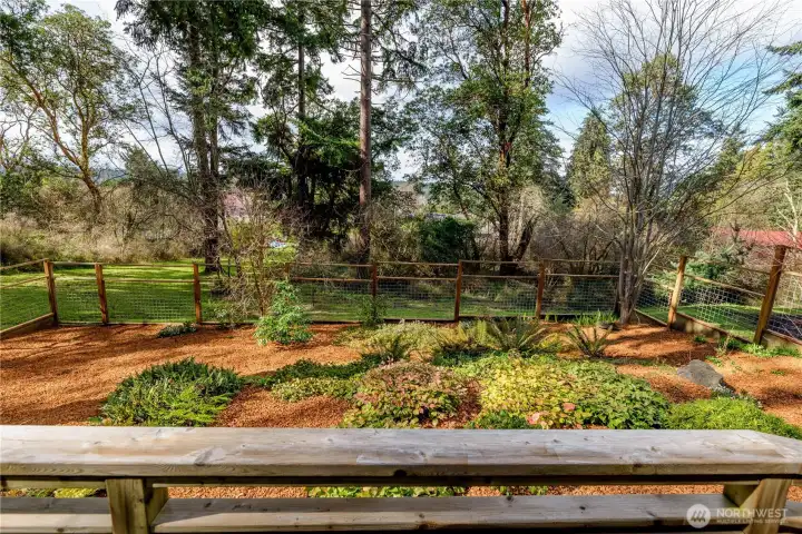 A south-facing veranda offers peaceful views of the Olympic Mountains, creating a welcoming outdoor space for quiet mornings, evening gatherings, and year-round enjoyment.