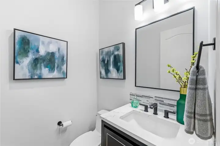 Powder room for day guests with a new vanity, sink and fixtures.