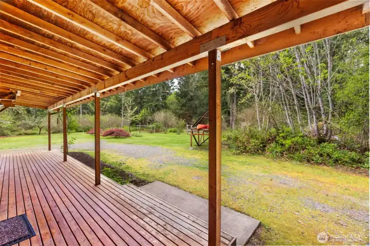 Veranda off of the living room leading to the wood shed and hand pump well.
