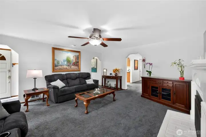 Living room with gas fireplace and ceiling fan