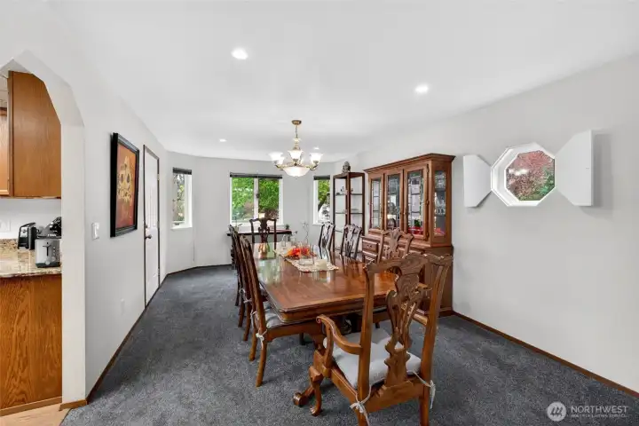 Bright, dining room with plenty of windows and space for entertaining and gathering and access to back deck