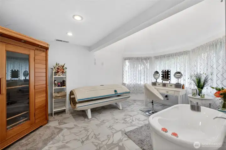 5 Piece Primary bathroom with oversized, walk in shower, sauna, tanning bed, double vanity, and stand alone bathtub