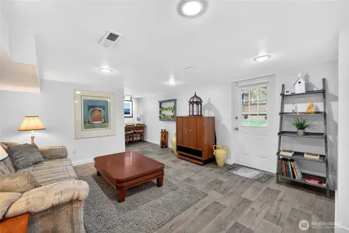 Downstairs, you will find even more living space! Large area to entertain and access to the backyard