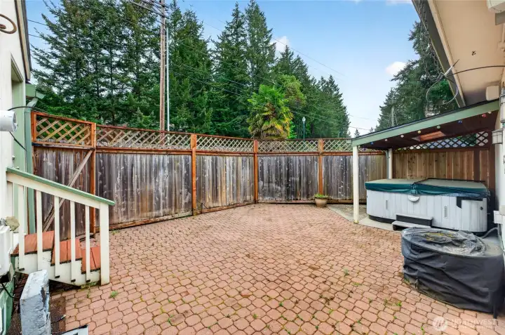 Covered hot tub with large, enclosed patio