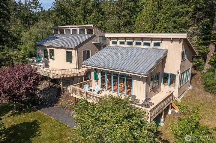 The west side of the structures, main house on the left, studio on the right. Both enjoy ample outdoor space provided by the decks.