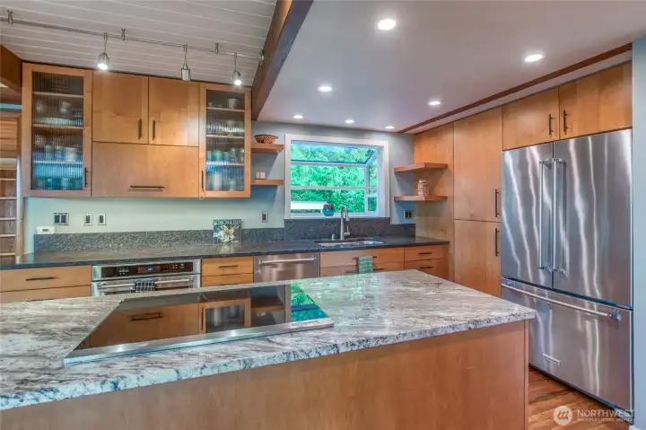 Plenty of counter space, large refrigerator, KitchenAid Induction cook top and plenty of cupboards makes this a cook's dream creative work space.