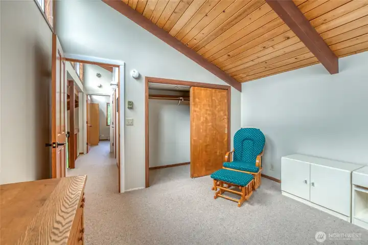 One of two upper bedrooms, vaulted ceiling and upper windows on the left.