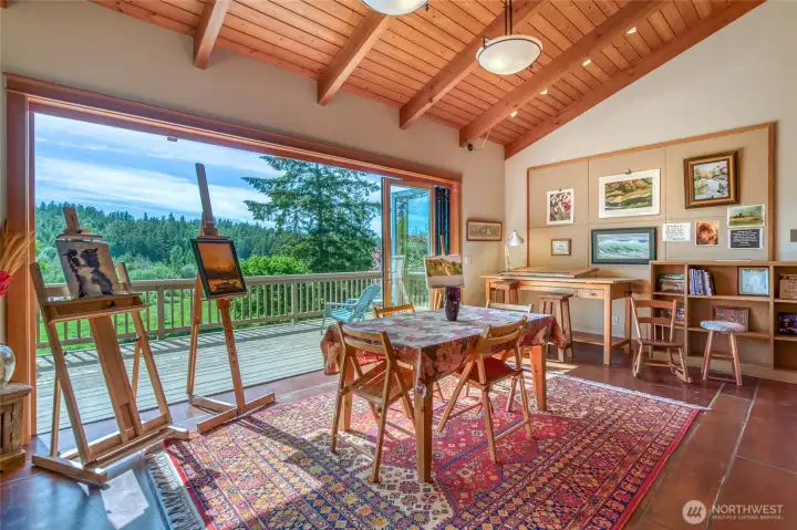 Glass folded doors open up to the deck, offering more space and great views!