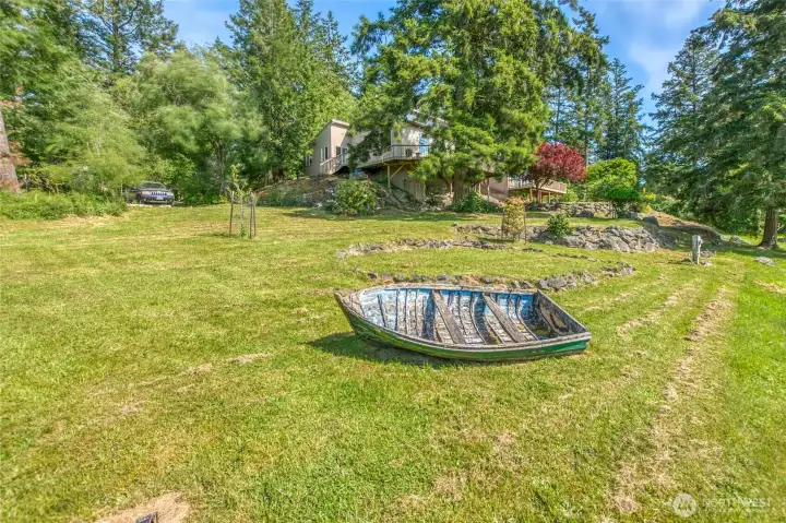 Terraced and level grass and garden areas on the north and west ends of the property. Native trees with pear, plum and apple trees.