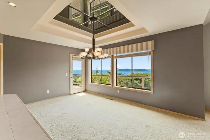 Dedicated dining area with panoramic water and island views, located adjacent to the sunken wet bar and offering direct access to the view deck for enjoying the scenery and coastal breezes.