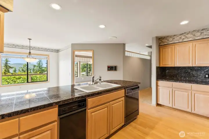 Designed with functionality in mind, the kitchen offers extensive cabinet storage, generous counter space, and a convenient buffet area for serving and gathering.