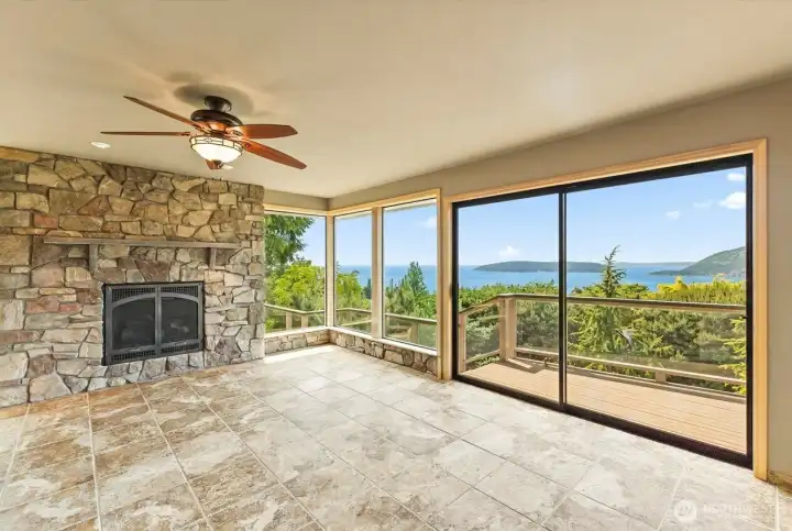 Designed to bring the outdoors in, the family room features expansive windows, a second fireplace, and panoramic water and island views that can be enjoyed rain or shine.