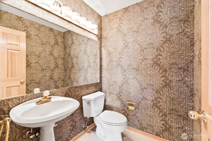 Stylish powder room with a distinctive decorative wall treatment, creating a memorable space for guests.