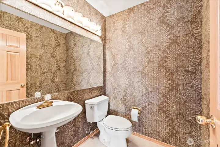 Stylish powder room with a distinctive decorative wall treatment.