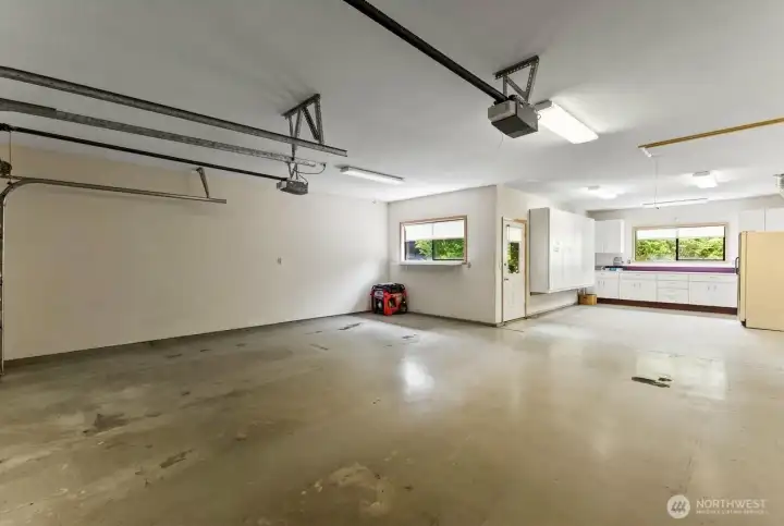 Expansive tandem garage provides room for up to three vehicles, plus space for recreational gear, hobbies, or a workshop area.