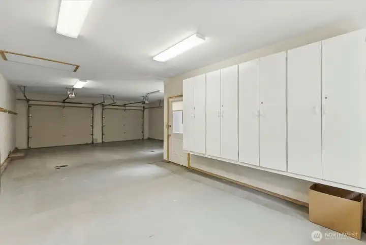 Custom built-in cabinetry provides extensive storage for tools, seasonal items, hobbies, and outdoor gear, helping keep the garage organized and clutter-free.