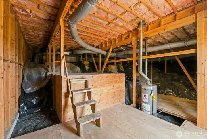 Huge unfinished basement with electricity, lighting, a second water heater, and outstanding storage and workshop potential.