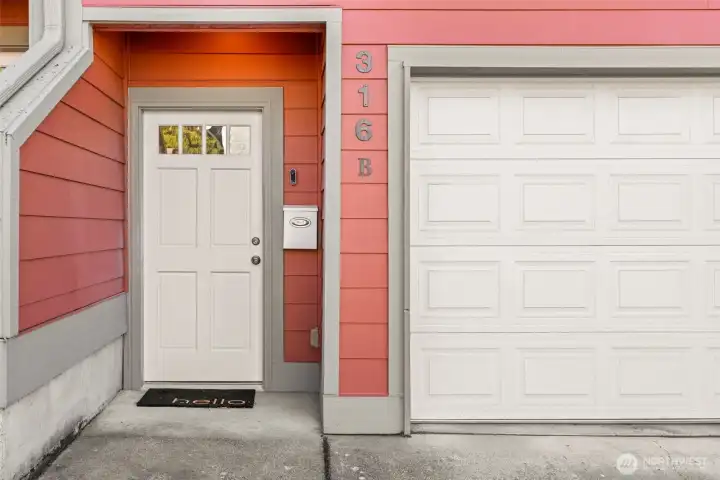 A welcoming front entrance with covered access alongside the 1-car garage.
