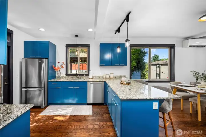 The functional layout features a large island that bridges the cooking and dining areas seamlessly.