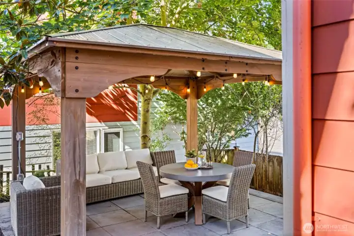 A covered backyard patio provides a shaded, private space for al fresco dining and relaxing year-round.