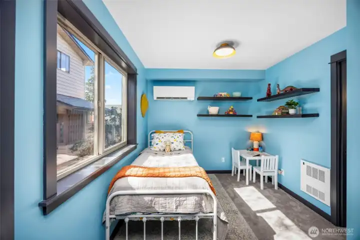 This secondary bedroom easily adapts to a nursery, guest space, or dedicated home office.