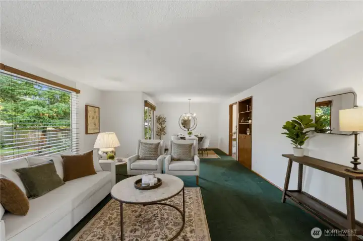 The formal living room flows seamlessly into the formal dining room, creating an inviting space for everyday living and entertaining alike. The formal living room flows seamlessly into the formal dining room, creating an inviting space for everyday living and entertaining alike.