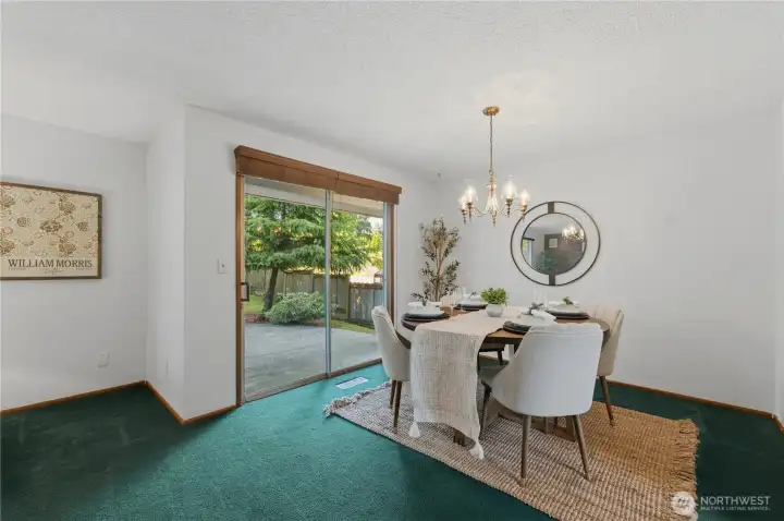 Sliding doors lead to a patio and sprawling, fully fenced backyard. Sliding doors lead to a patio and sprawling, fully fenced backyard.