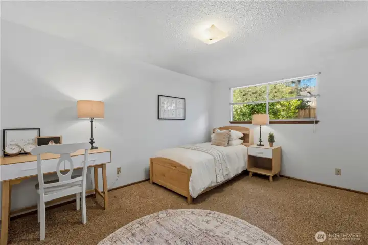 This is the larger of two additional bedrooms on the main floor, featuring a large picture window. This is the larger of two additional bedrooms on the main floor, featuring a large picture window.