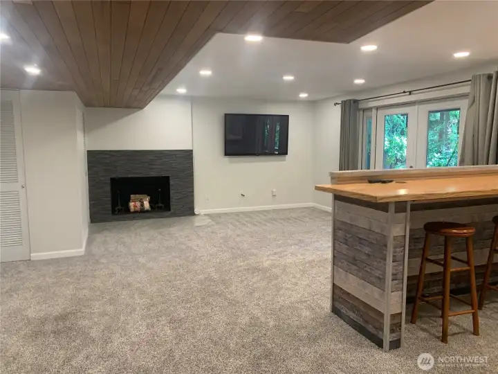 Lower living room, French doors & fireplace