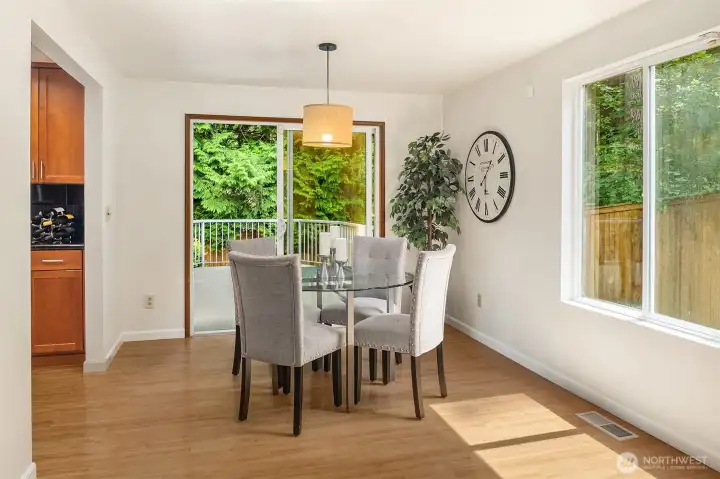 The large, renovated kitchen centers the living space ~ warm wood cabinetry, granite countertops with plenty of prep area, and adjacent dining room.