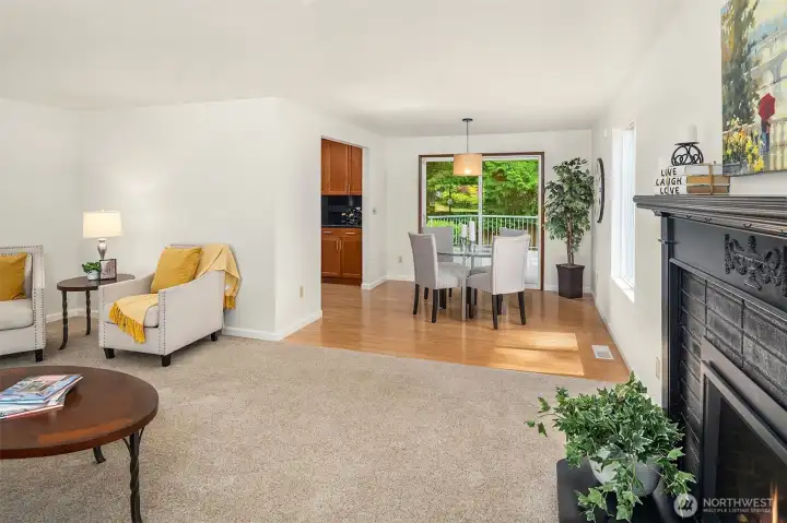 The large, renovated kitchen centers the living space ~ warm wood cabinetry, granite countertops with plenty of prep area, and adjacent dining room.