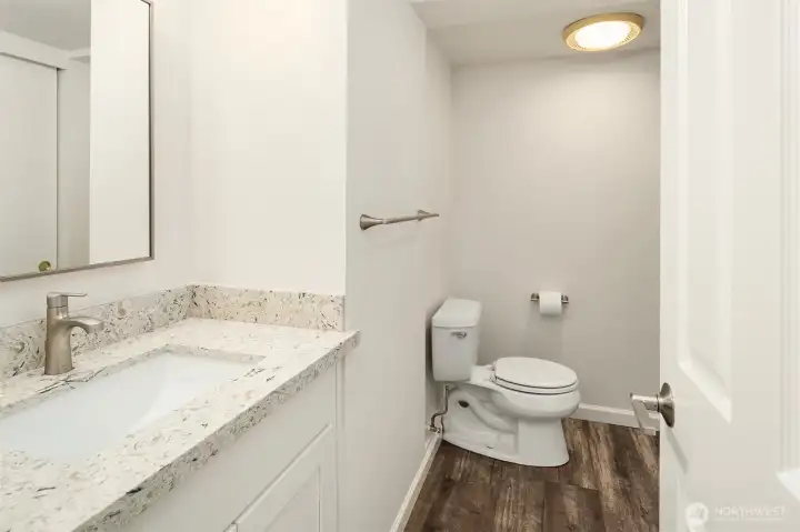 Updated lower level 3/4 bath with new vanity and granite countertop.