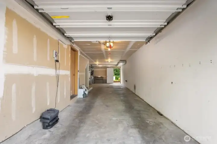 Tandem garage with door leading to back yard