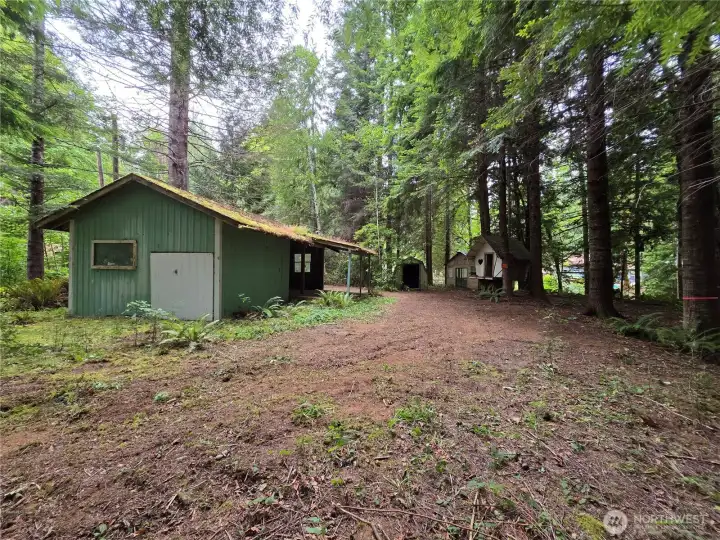 Rv cover, tree house, shed and rustic camping cabin, ribbons mark back property line