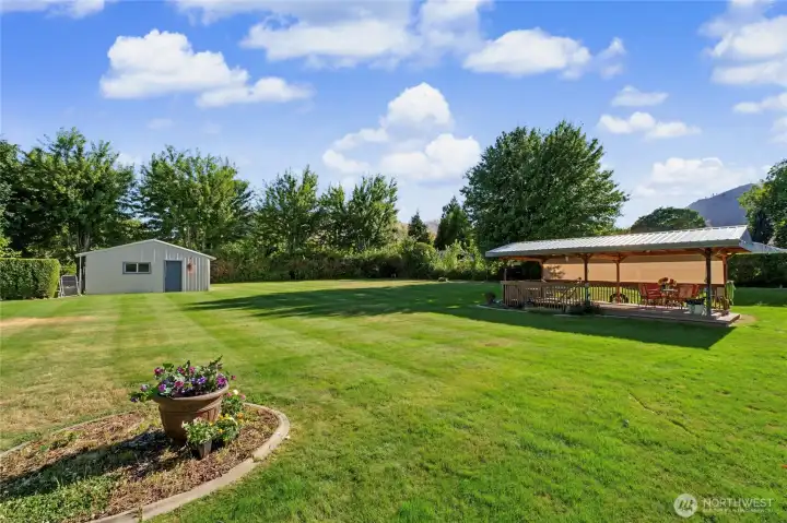 Expansive backyard with large gazebo and storage shed