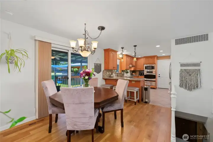 Open floorplan dining with slider to covered deck